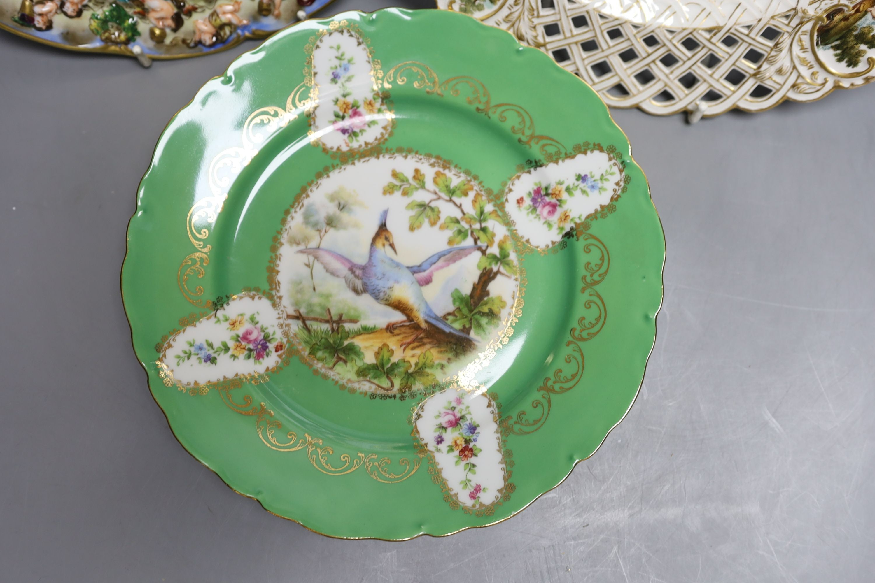 A Dresden armorial ribbon plate, two Sevres style plates and a Capodimonte style plate, late 19th/early 20th century (4)